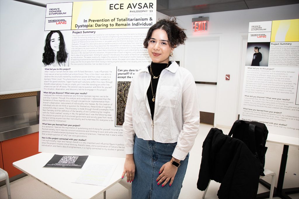 Ece Avsar stands next to her poster on display at the Dean's Honor Symposium.